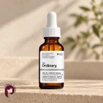 بطری سرم آلوئه ۲٪ و NAG ۲٪ اوردینری روی سطح سنگی روشن